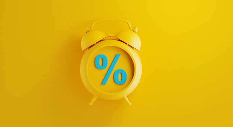 Yellow alarm clock on yellow background. There is a blue percentage sign on the clock. Reminder concept. Horizontal composition with copy space.